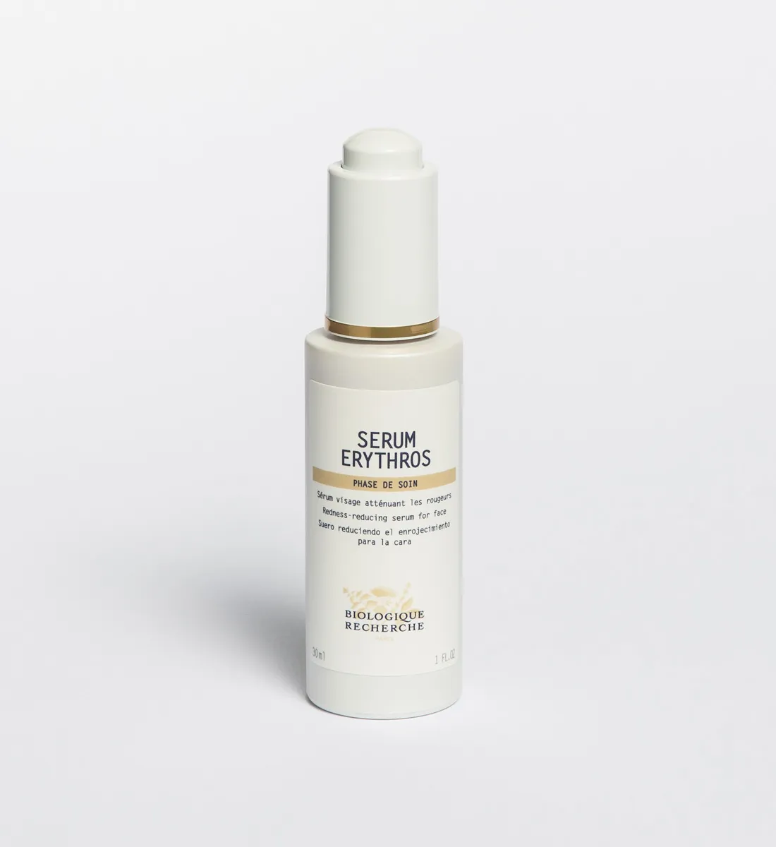 Белый флакон сыворотки Serum Erythros Biologique Recherche 30 мл с дозатором-пипеткой на светло-сером фоне